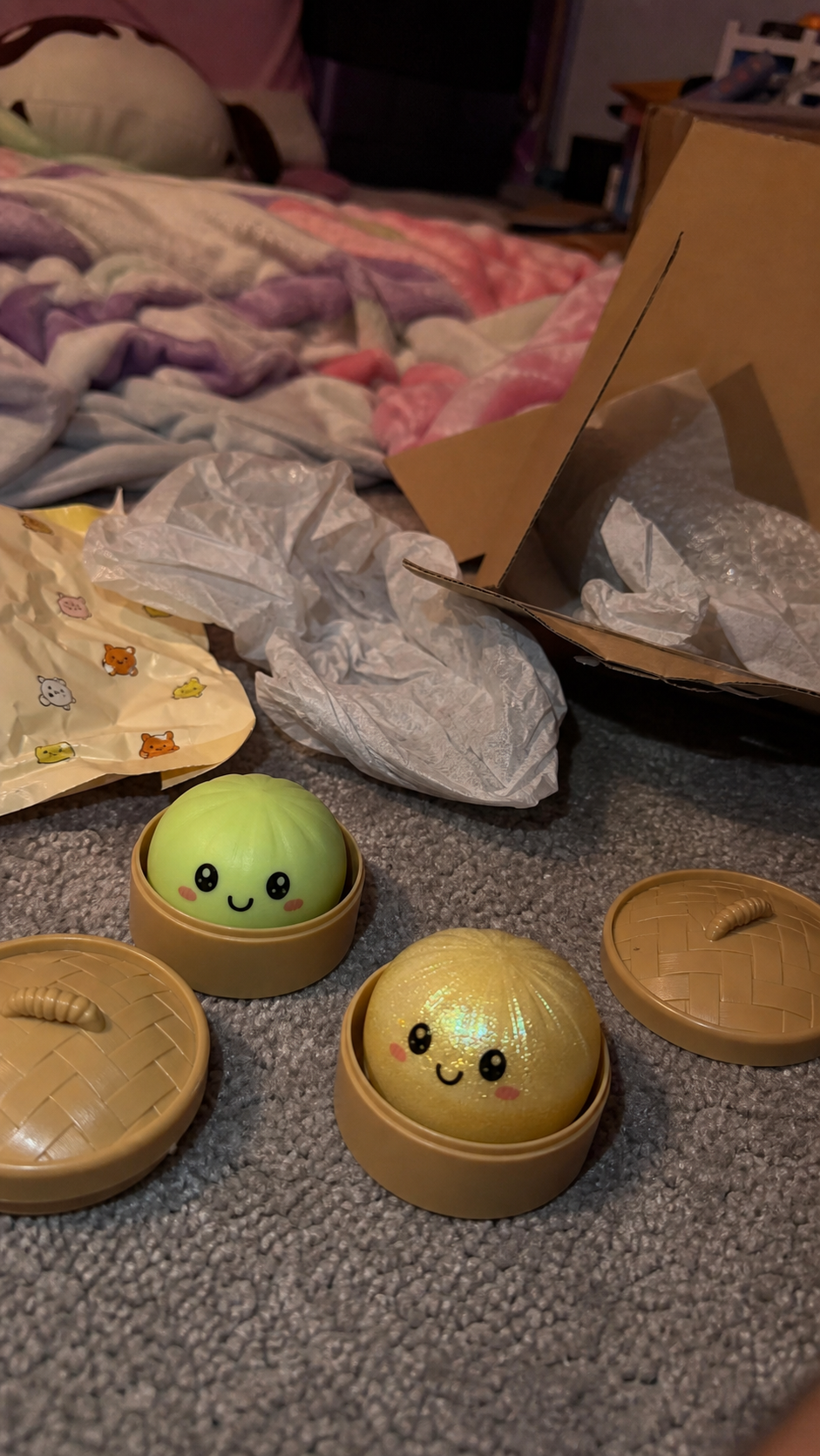Green and glitter Dumpling Squishy toys opened on a bedroom floor