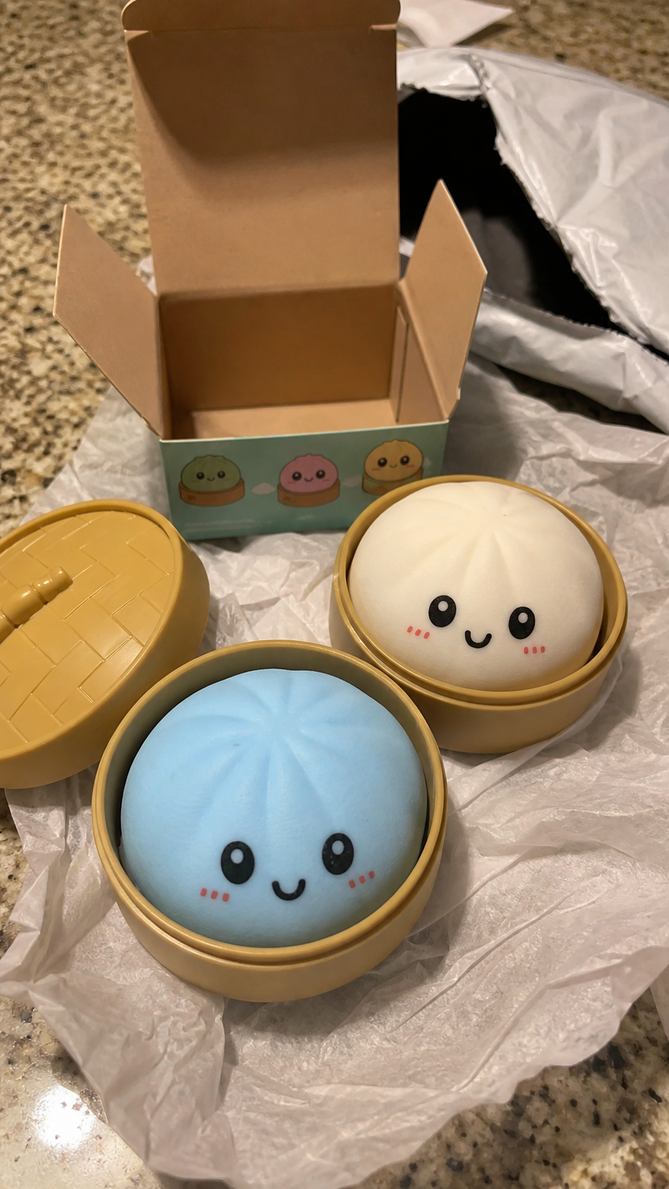 Dumpling Squishy toys unboxed on a kitchen counter