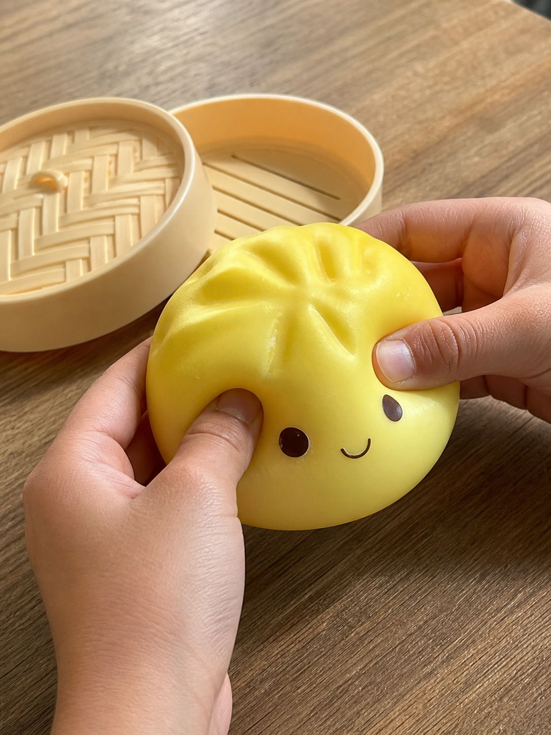 Yellow Dumpling Squishy being squeezed by hand