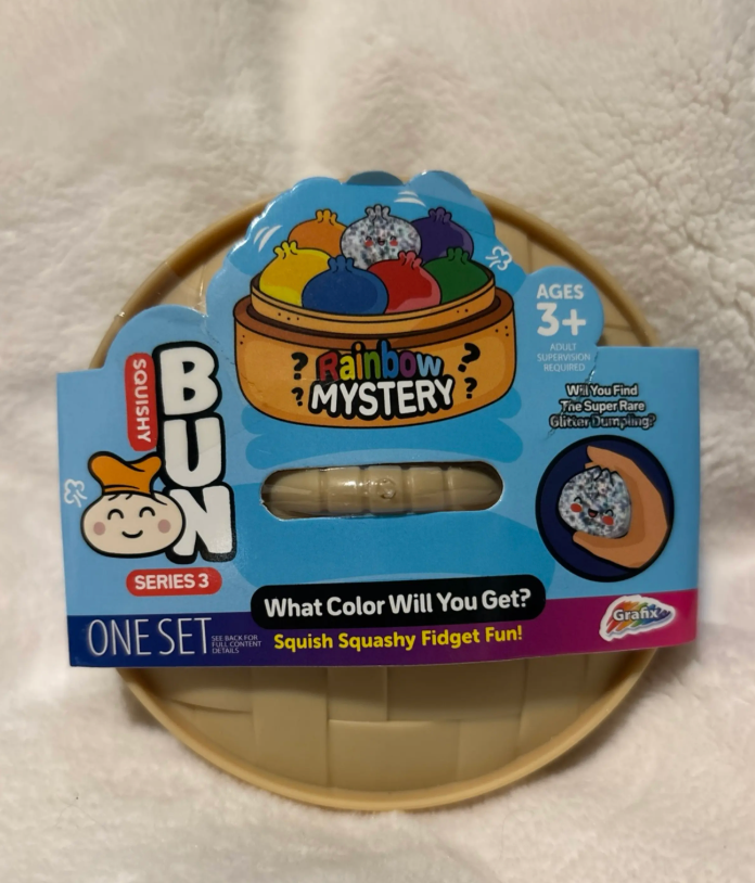 Mystery Dumpling Squishy package on a soft white blanket