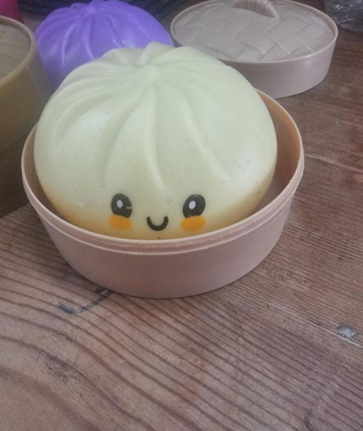 White Dumpling Squishy displayed on a wooden table