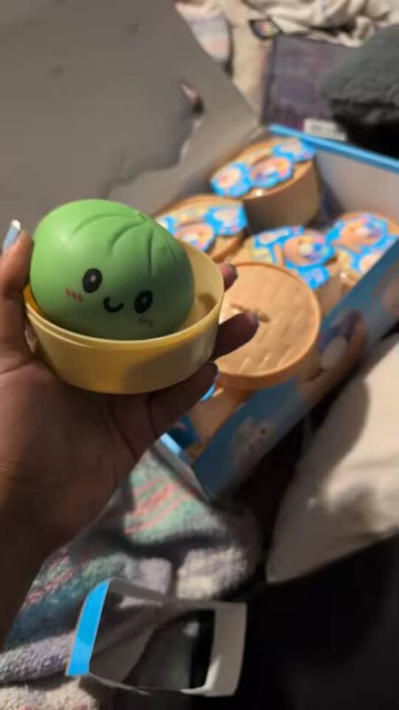Green Dumpling Squishy held after unboxing
